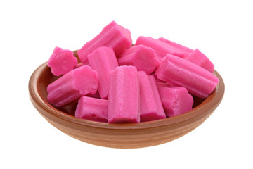 Bowl of pink bubble gum on a white background