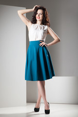 Colorful photo of a woman in white top and dark blue skirt