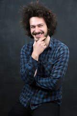 Portrait of a fashionable young man on dark background, chalkboa