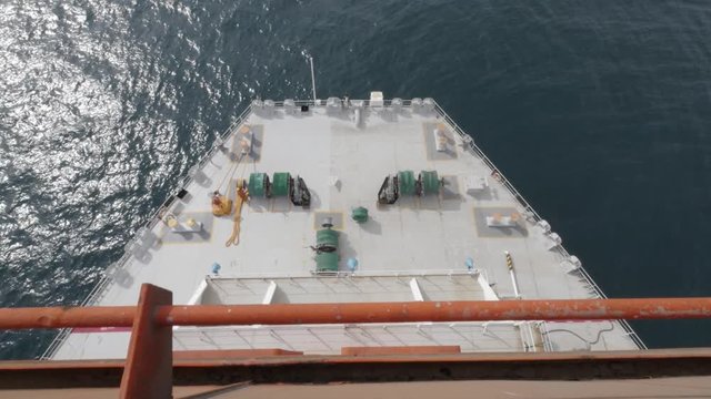 Aft of large vessel in ocean and seamen on deck top view