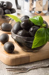 Foto op Plexiglas Black olives in glass cups decorated with green leaves © romensky