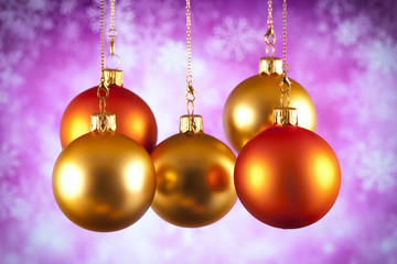 Gold and red Christmas baubles on abstract background