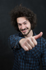 Portrait of a fashionable young man on dark background, chalkboa