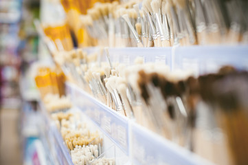 Paint brushes on the shelf a store window. goods to the store to stock of art and creativity, drawing tool, blur closeup