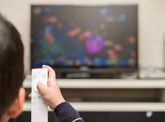 kid playing a TV game with remote control