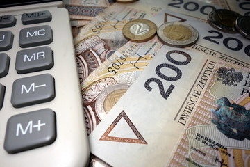 Polish finances - two hundred zloty banknotes and a calculator 