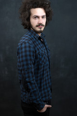 Portrait of a fashionable young man on dark background, chalkboa