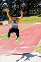 Fototapeta premium Athlete performing a long jump