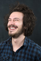 Portrait of a fashionable young man on dark background, chalkboa