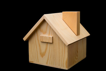 Obraz na płótnie Canvas wooden house model on black background