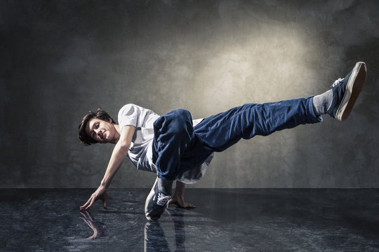 urban hip hop dancer over grunge concrete wall - Powered by Adobe