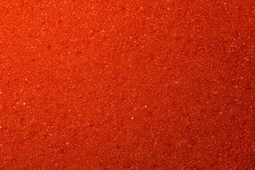 Background of red sponge for dishes. Macro