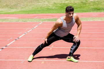 Obraz premium Athlete warming up on the running track