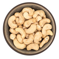 Bio organic cashews in ceramic bowl isolated on white background, top view
