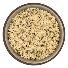 Bio organic hemp seeds in ceramic bowl isolated on white background, top view