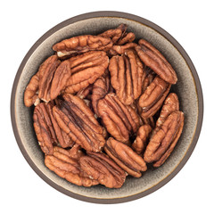 Bio organic pecans in ceramic bowl isolated on white background, top view