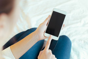 Woman with modern mobile phone in hands