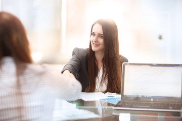 Two Businesswomen Having Informal Meeting In Modern Office