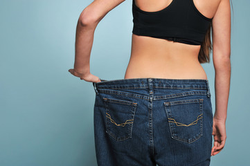 Fit young woman in loose jeans