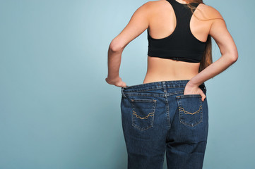 Women shows her weight loss.