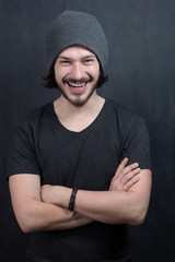 Portrait of a fashionable young man on dark background, chalkboa