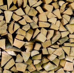 Pile of chopped fire wood logs prepared for winter. Close up.