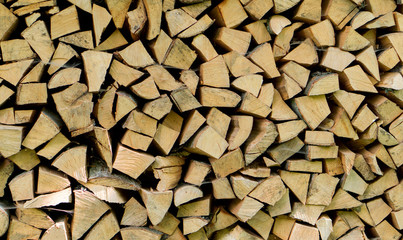 Pile of chopped fire wood logs prepared for winter. Close up