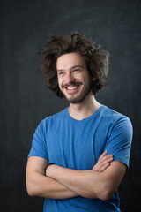 Portrait of a fashionable young man on dark background, chalkboa