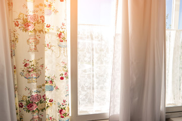 Curtains and window. Sunlight in the window. Meet new day. Feel warmth of home.