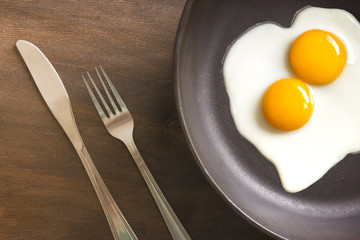 fried eggs with knife and fork