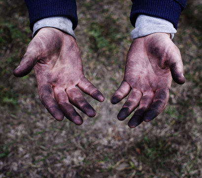 Hands of a mechanic in oil and fuel oil, close up