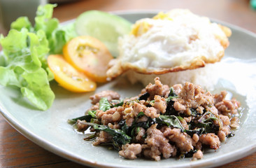 Stir-fried pork with basil leaves and fried egg on rice.