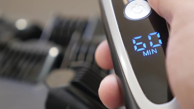 Modern multi-cut clipper LED display close-up 4K 2160p 30fps UHD footage - Sixty minutes battery autonomy on cordless barber set 3840X2160 UltraHD video 
