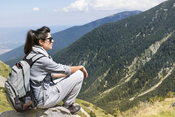 woman backpacker on a mountain peak