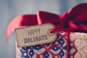 gift with a label with the text happy holidays