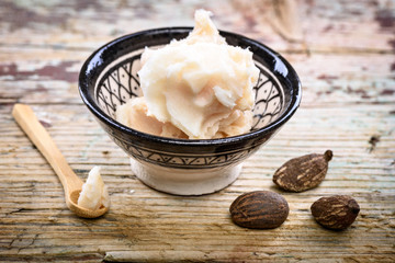 shea butter and nuts on a wooden table
