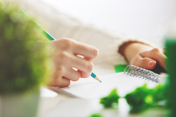 Girl writing in spiral notepad
