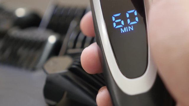 Close-up of modern multi-cut clipper LED display 4K 2160p 30fps UHD footage - Sixty minutes battery autonomy on cordless barber set 3840X2160 UltraHD video 