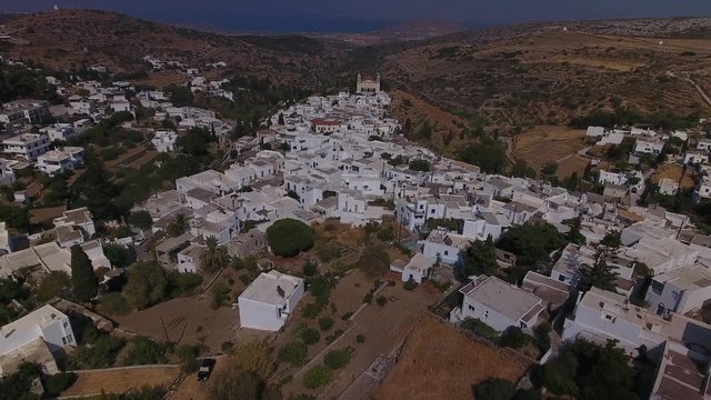 Aerial shot of a sloping village built on a mountains. Camera climbs higher, showing more and more houses.