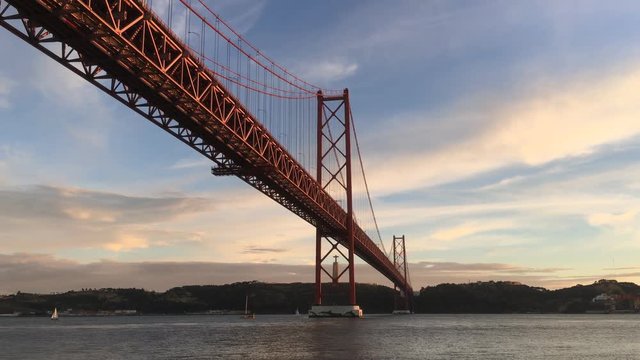 Lisbon Suspension Bridge On Tagus River During Sunset, Portugal. The 25 de Abril Bridge is a suspension bridge connecting the city of Lisbon to the municipality of Almada.