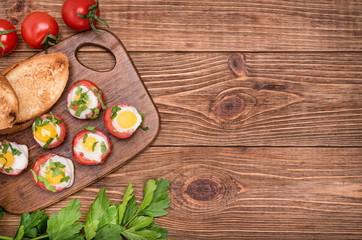 Baked eggs in tomato cups. 