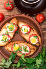 Baked eggs in tomato cups. Breakfast.