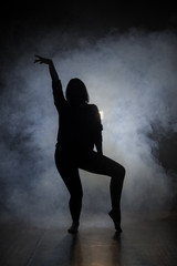Naklejka na ściany i meble Dancer in the dark and smoke