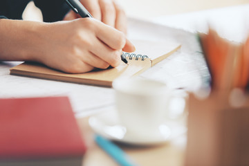 Female writing in notepad