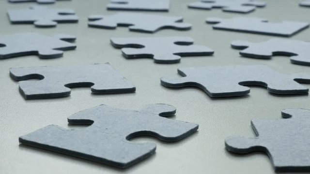 Lot of blue pieces of jigsaw puzzle on the table shallow DOF 4K 2160p 30fps UHD tilting footage - Toy problem solving arranged chaotically slow tilt 3840X2160 UltraHD video 