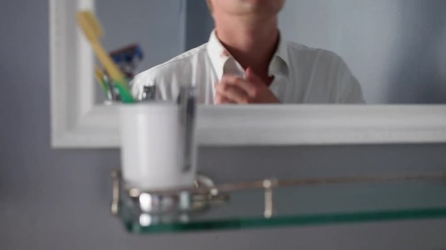 Reflection Of Man In Bathroom Mirror, Trying To Get Lipstick Off His Collar