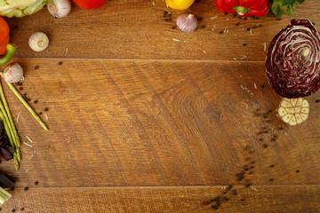 wooden background with vegetables and spices
