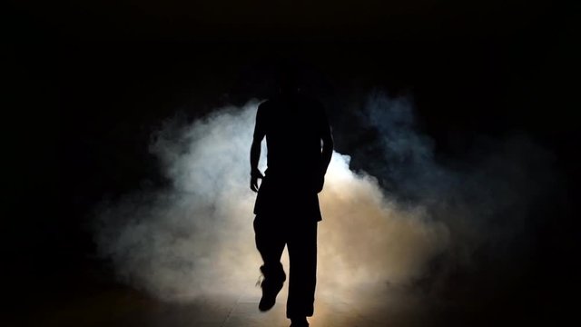 Dancer in a smoke on a black background