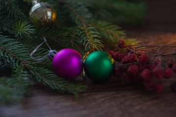 Fototapeta na wymiar Christmas decorations on a Christmas tree branch on wood