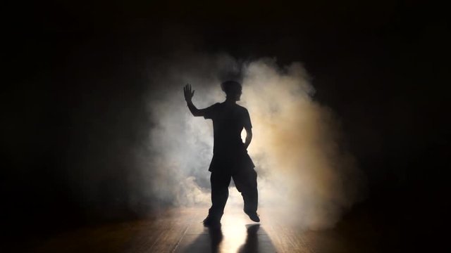 Dancer in the smoke in the dark.